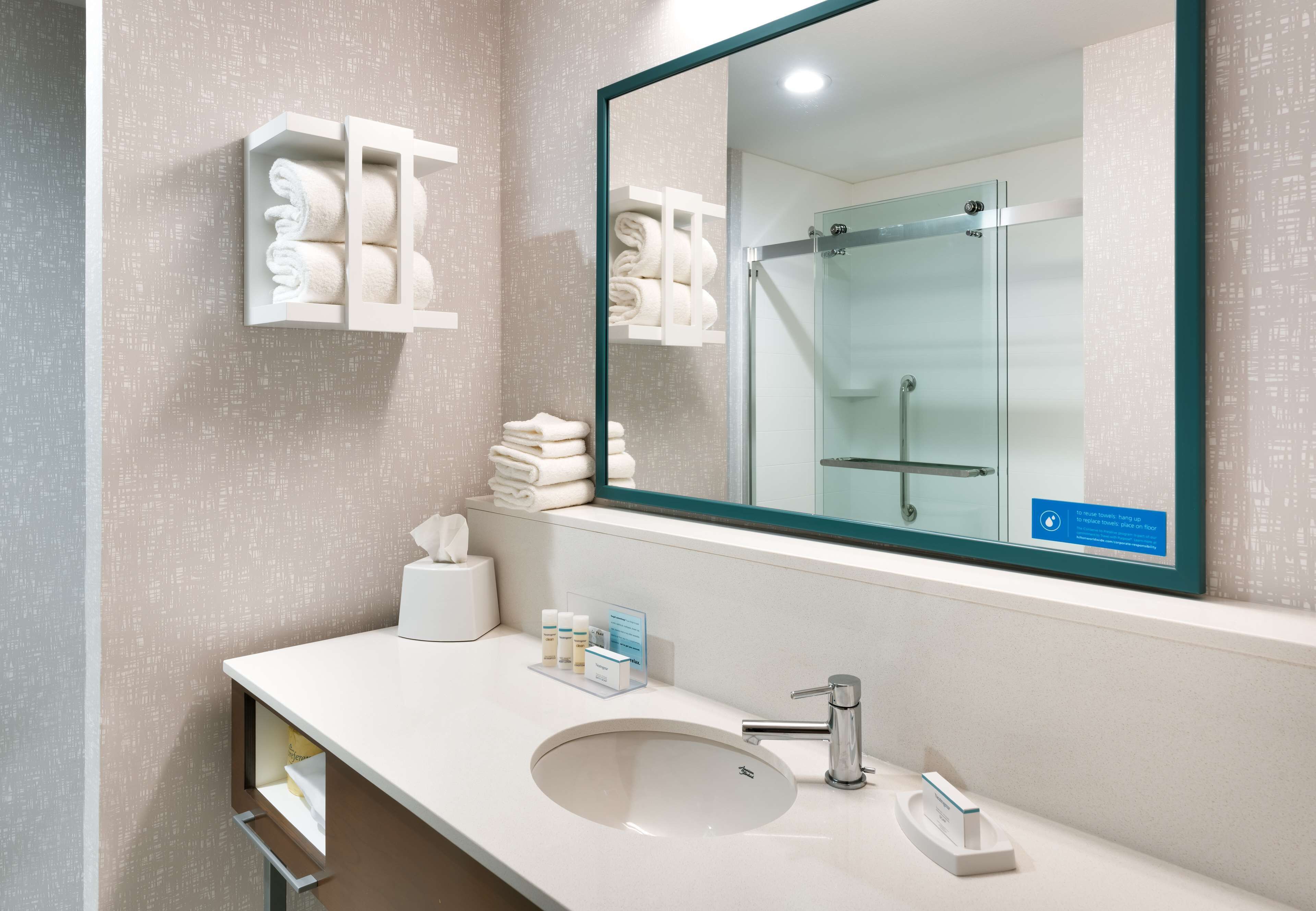 designer toiletries, hair dryer, towels