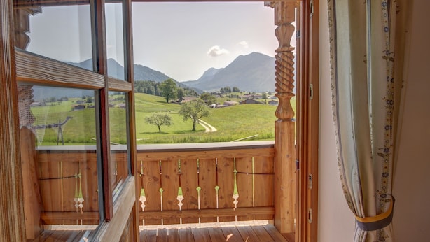 A wooden balcony with a view of a green landscape and mountains. - Vacation apartment Hochstaufen for 4 persons, 2 bedrooms, 80 sqm (Inzell)