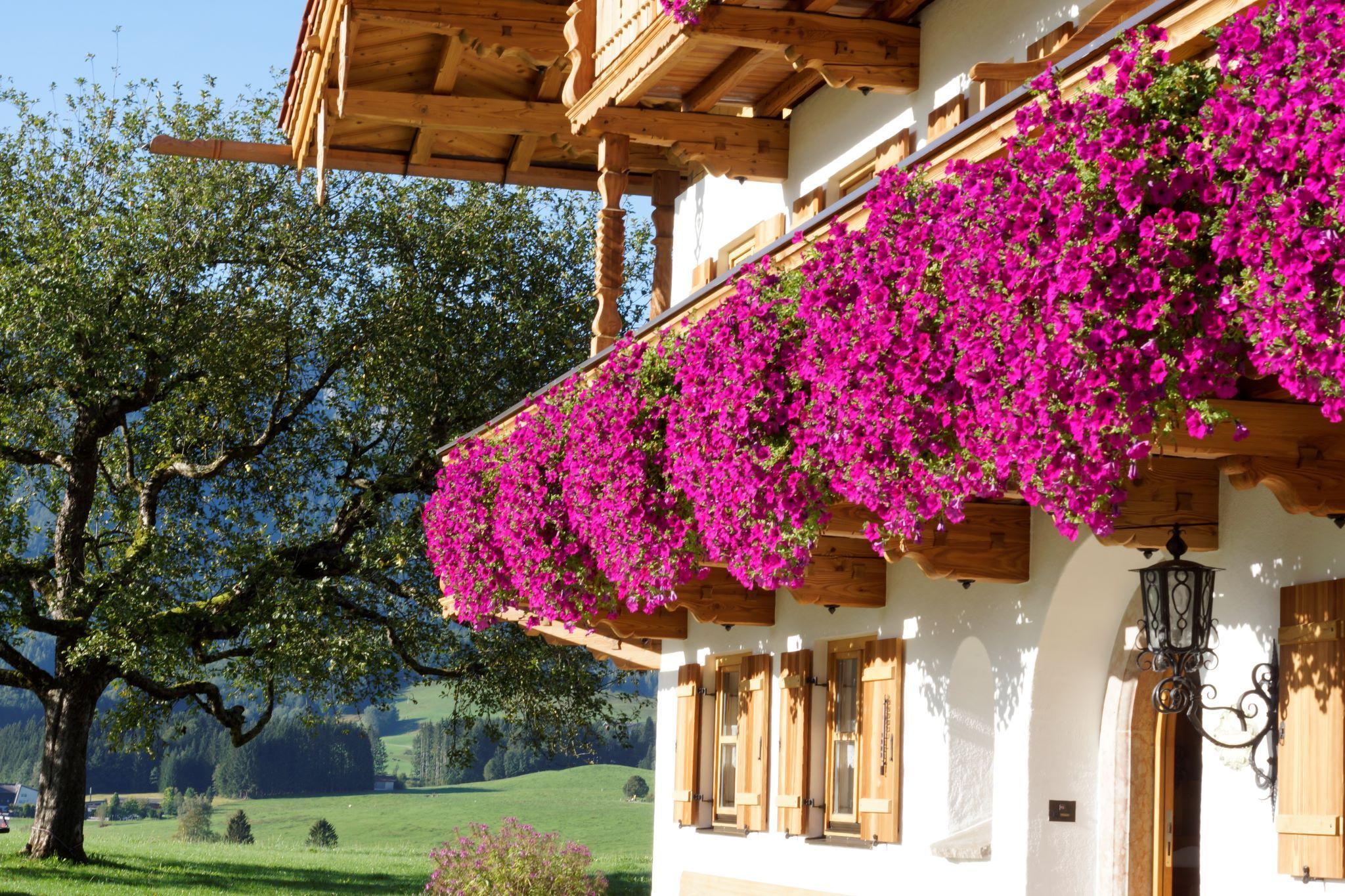 A traditional chalet with wooden balconies and flower boxes.