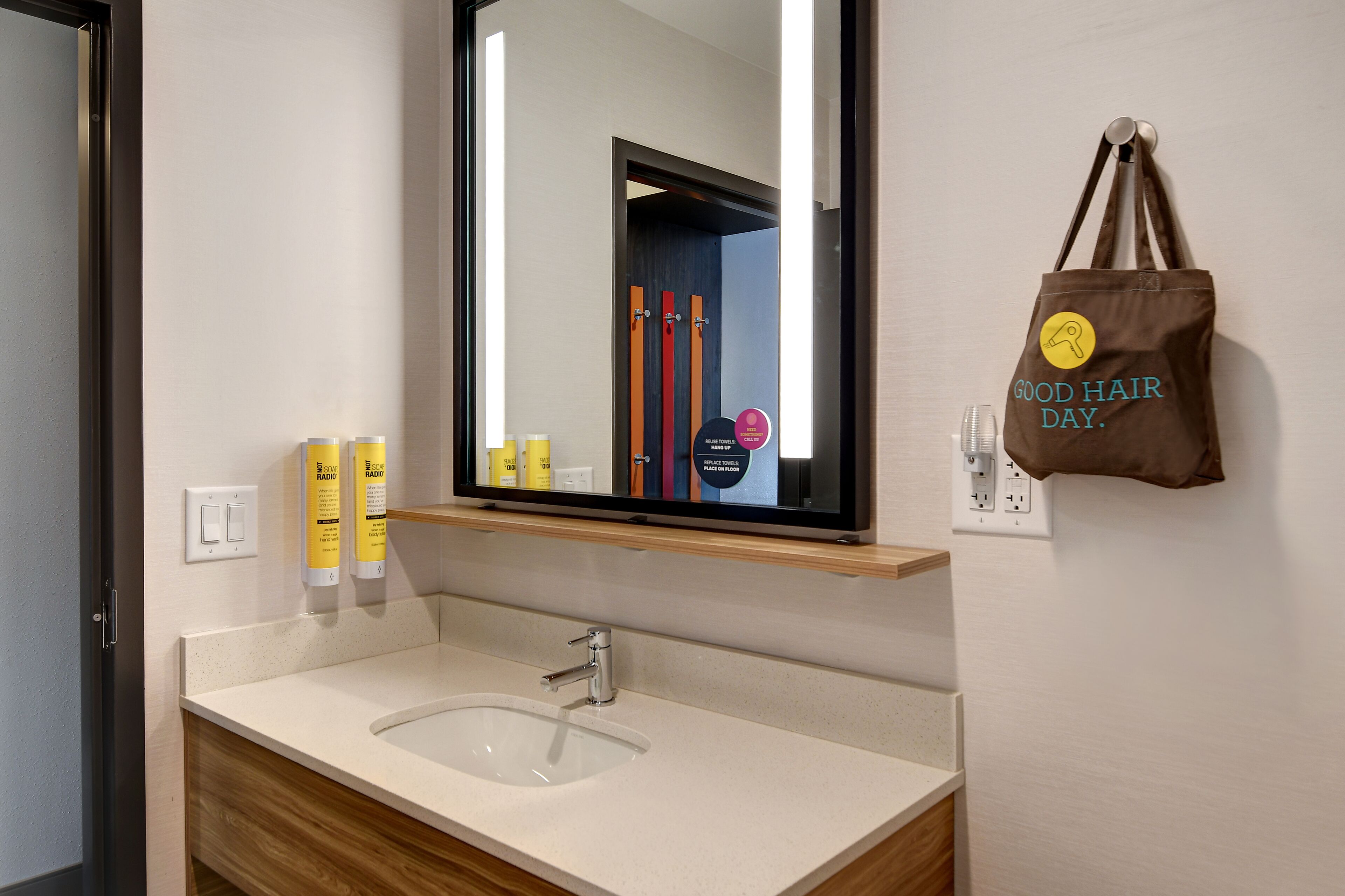 designer toiletries, hair dryer, towels, soap