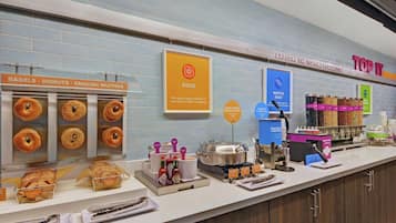 A breakfast counter with various food items and condiments.