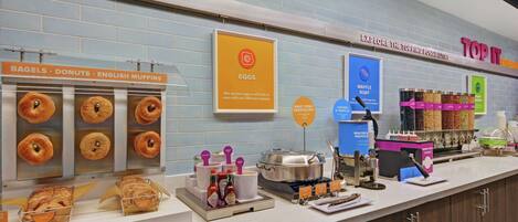 A breakfast counter with various food items and condiments.