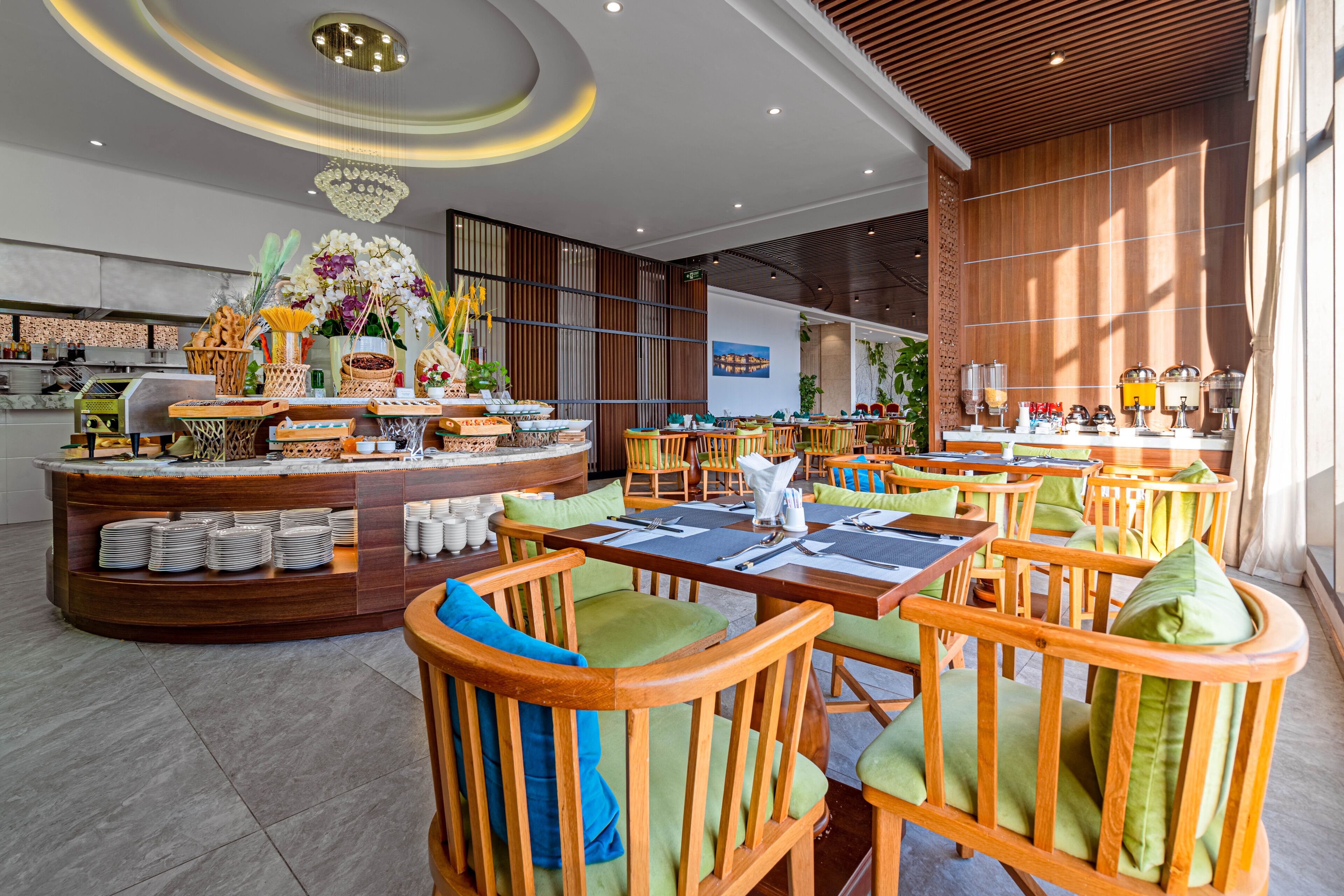 A modern restaurant with wooden furniture, a buffet area, and a chandelier.