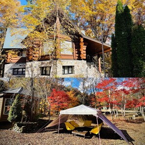 A log cabin with a stone foundation, a wooden upper structure, and a large porch. - Hakuba Canadian Lodge (Hakuba)