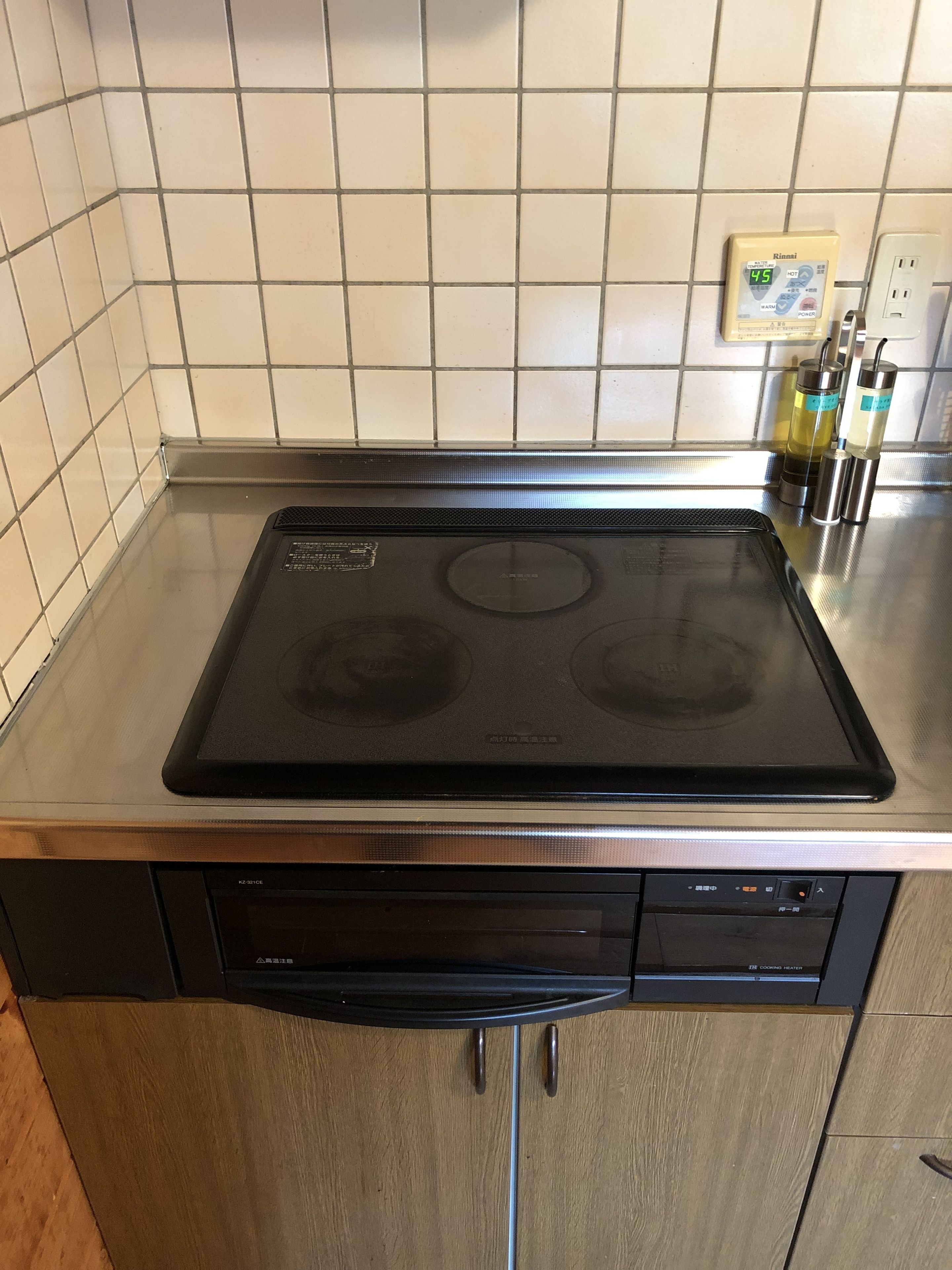 A kitchen with a black stove, a dishwasher, and a tiled backsplash.