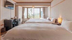 A hotel room with two beds, a desk, and a TV. - SUMMIT VIEWS HAKUBA (Hakuba)