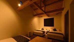 A cozy room with two beds, a wooden ceiling, and a large window. - Hinata-an (Yufu)