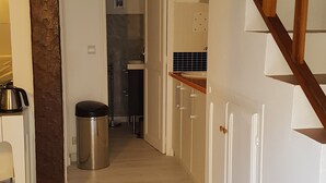 A hallway leading to a kitchen with a wooden staircase. - Little Villa "La Maredda" in Porticcio with sea view terrace and beach at 250m! (Porticcio-Grosseto-Prugna)