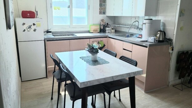 A compact kitchen with a dining table, chairs, a refrigerator, and a window. - YeoU (Mungyeong)
