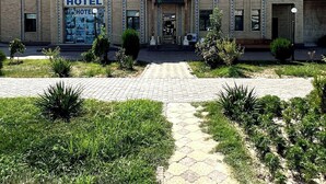 A two-story building with a sign reading "HOTEL" and "UMAR" on the top. - Hotel UMAR (Khiva)
