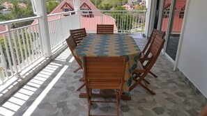 Enjoy meals on the balcony with a view of the surrounding neighborhood.