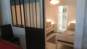 A room with a bed, a chair, a wardrobe, and a mirror. - La Campanette in Luberon, private pool. (Cheval Blanc)
