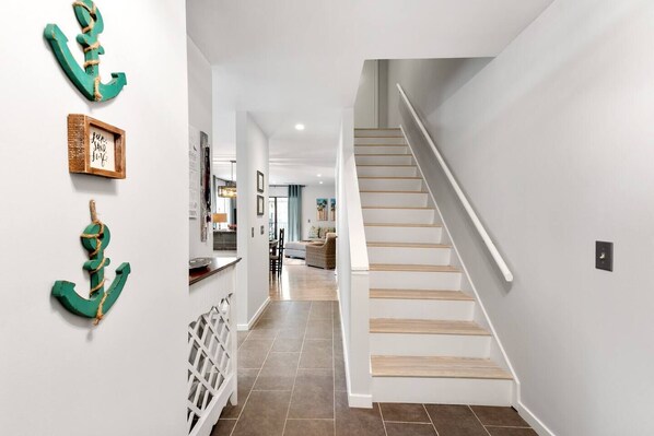 A modern interior with a staircase leading to a living area.