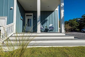 A house with a porch, a door, and steps leading to the entrance. - Heated Private Pool*, Walk to the Beach! Golf Cart & 6 Bikes! - Blue Dune 30A in Blue Mountain Beach (Santa Rosa Beach)