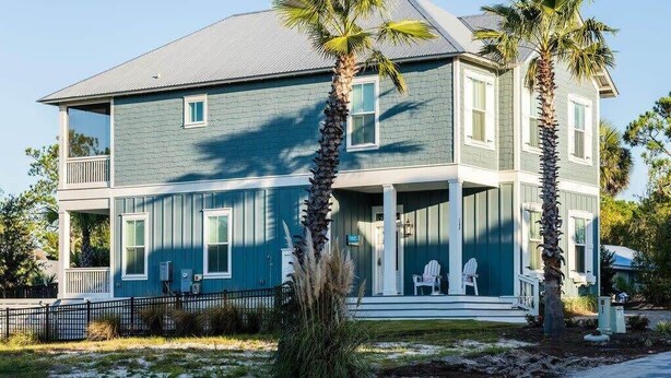 A two-story house with a porch, a small deck, and a fenced yard. - Heated Private Pool*, Walk to the Beach! Golf Cart & 6 Bikes! - Blue Dune 30A in Blue Mountain Beach (Santa Rosa Beach)