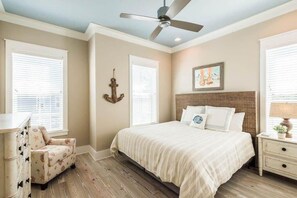 A bedroom with a bed, nightstand, dresser, chair, and a ceiling fan. - Heated Private Pool*, Walk to the Beach! Golf Cart & 6 Bikes! - Blue Dune 30A in Blue Mountain Beach (Santa Rosa Beach)