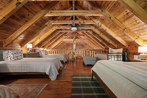 A cozy attic bedroom with wooden beams, two beds, a ceiling fan, and a view of the outdoors. - Boat Days Begin Here, Walk to  Hurricane Marina (silver point)