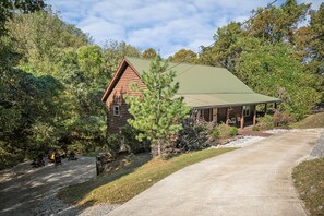 A log cabin with a porch, surrounded by trees and a gravel path leading to it. - Boat Days Begin Here, Walk to  Hurricane Marina (silver point)