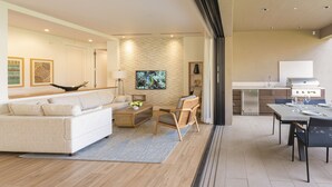 Un salon moderne comprenant un canapé, une table basse et un coin repas avec une table et des chaises.