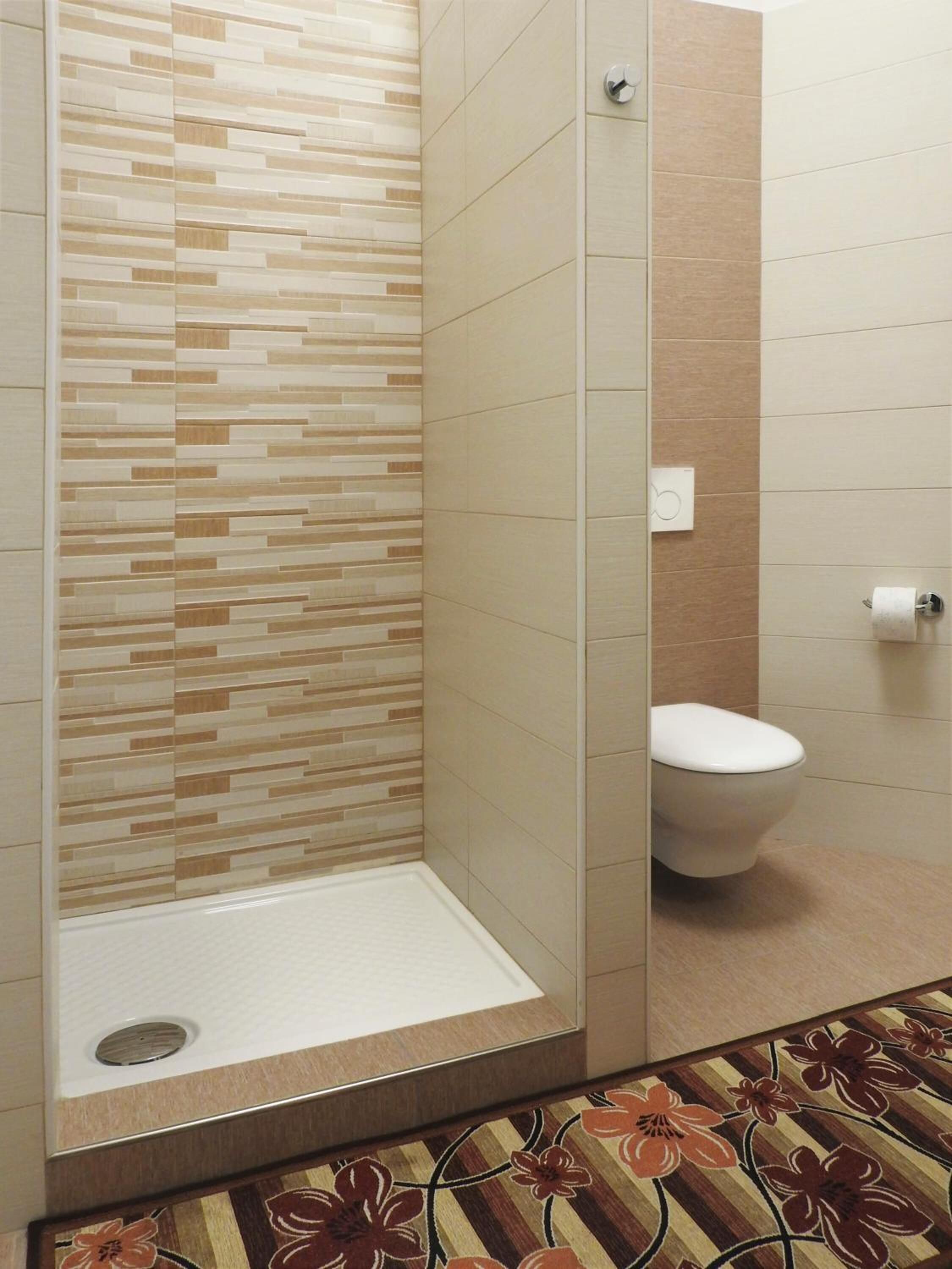 shower, rainfall showerhead, hair dryer, towels