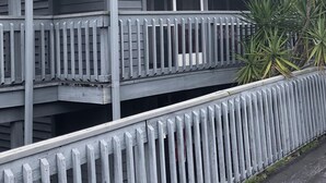 A multi-story building with balconies and a gated entrance. - Cozy Condo on the water (Dunnellon)