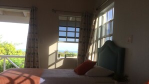 A bedroom with two beds, a view of the outdoors, and a window with curtains. - Sugar Fields Hoilday Home with Private Pool. (Valley Church)