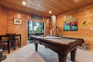 A wooden cabin interior with a pool table, a sign reading 'CABIN FEVER', and a moose crossing sign. - Drink Up The View - Morganton (Morganton)