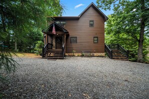 A wooden cabin with a porch, steps, and a flag. - Drink Up The View - Morganton (Morganton)