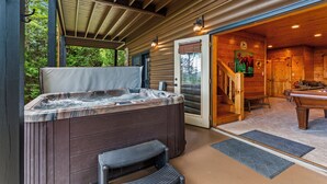 A wooden cabin with a hot tub, a pool table, and a staircase leading to the main room. - Drink Up The View - Morganton (Morganton)