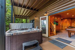 A wooden cabin with a hot tub, a pool table, and a staircase leading to the main room. - Drink Up The View - Morganton (Morganton)