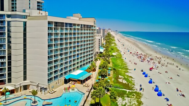 A hotel with a pool, beach access, and a view of the ocean. - Oceanfront Studio Retreat on the Golden Mile (Myrtle Beach)