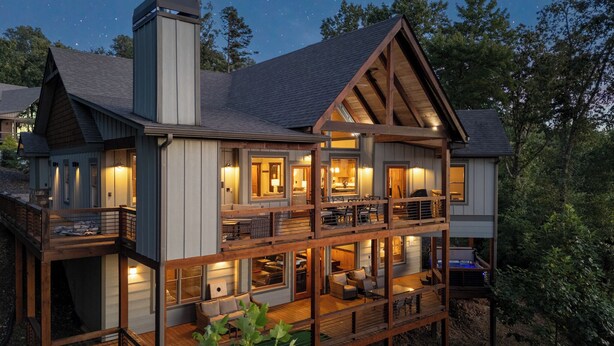 A multi-story cabin with a balcony, large windows, and a fireplace. - New Heights - Blue Ridge GA (Blue Ridge)