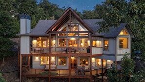 A large, multi-story house with a balcony and deck, featuring multiple windows and a chimney. - New Heights - Blue Ridge GA (Blue Ridge)