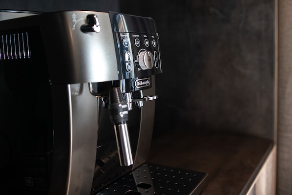 A coffee machine with a control panel, a drip tray, and a water reservoir. - Apart Sailers (Sankt Anton am Arlberg)