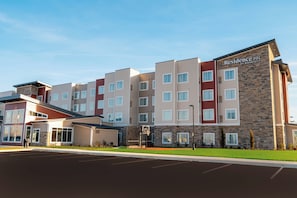 Experience the Residence Inn's welcoming entrance, featuring a covered area with a glass door and well-maintained parking.