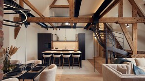 A modern kitchen with a central island, wooden beams, and a staircase. - Van der Valk Hotel Mechelen (Mechelen)
