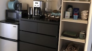 A compact kitchenette with a microwave, coffee maker, and storage drawers. - Serene Sedona Studio w/ double shower and private patio with view! (Sedona)