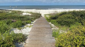 A wooden boardwalk leading to a beach with a clear view of the ocean. - Quaint, private gulf front on North Cape, NEW kitchen and bathrooms! (Port St Joe)