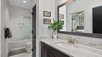 Combined shower/tub, hair dryer, towels, soap
