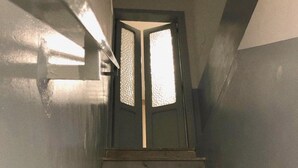 A staircase with a door at the top. - Torre Tresca 2 (Bari)