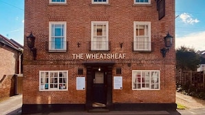 A two-story brick building with a black roof, named "THE WHEATSHEAF." - The Wheatsheaf Inn (Nottingham)