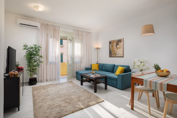Classic Apartment, Balcony | Living area | Flat-screen TV