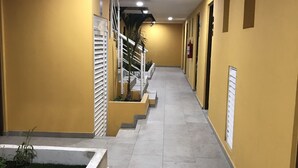 A hallway with yellow walls, a staircase, and a ceiling with recessed lighting. - Suite Riviera 211 *Rooftop Pool* (Playa del Carmen)
