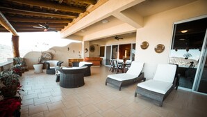 An outdoor patio with lounge chairs, a dining area, and potted plants. - Sleeps 6, amazing La Ropa bay views, newly available , over 3000 square feet! (Zihuatanejo)