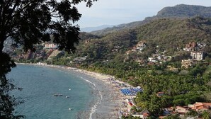 A coastal town with a beach, houses, and hills in the background. - Sleeps 6, amazing La Ropa bay views, newly available , over 3000 square feet! (Zihuatanejo)