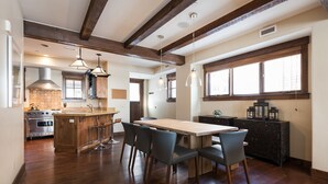 A spacious kitchen with a wooden island, modern appliances, and ample natural light.