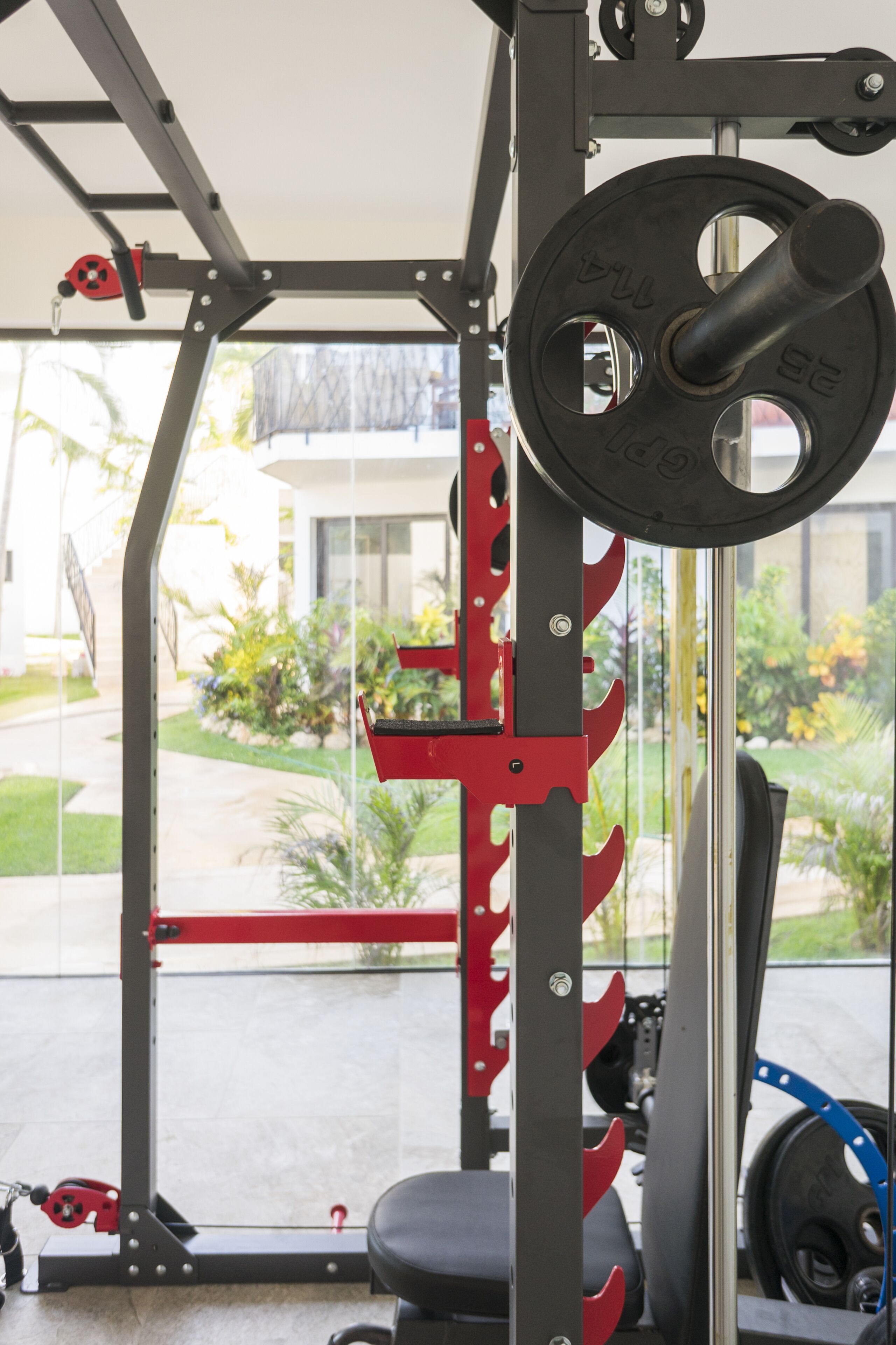 Un espace dédié à la musculation, équipé d’un support à squats, d’un banc et de poids.