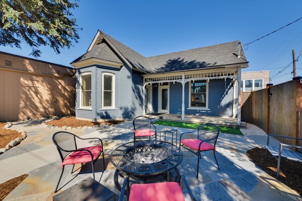 A house with a blue exterior, a covered porch, and a fire pit with four chairs. - 0547: Downtown Salida Home, 1 Block to Main Street (Salida)