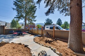 A backyard with a patio, seating area, and a dinosaur statue. - 0547: Downtown Salida Home, 1 Block to Main Street (Salida)