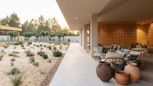 A modern outdoor lounge area with seating and planters. - Spatia Comporta, a Member of Design Hotels (Grandola)